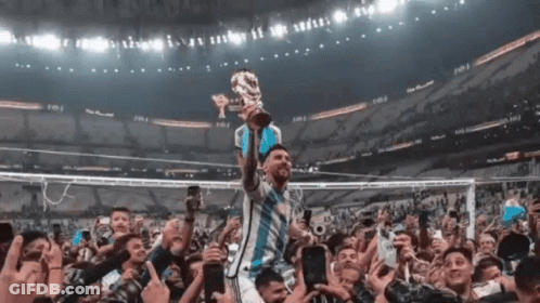 Soccer Player Holding Trophy In Front Of Crowd GIF