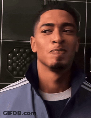 Soccer Player Holding Trophy In Front Of Real Madrid Campeon De La Champions League Sign GIF