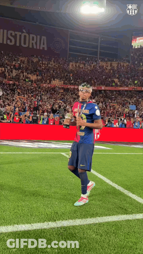 Soccer Player Holding Trophy On Field With Historia GIF