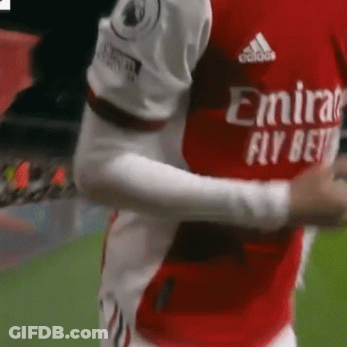 Soccer Player Hugging Teammate In Red And White Jersey GIF