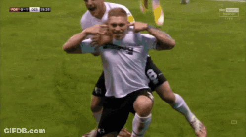 Soccer Player In 32Red Jersey Being Congratulated GIF