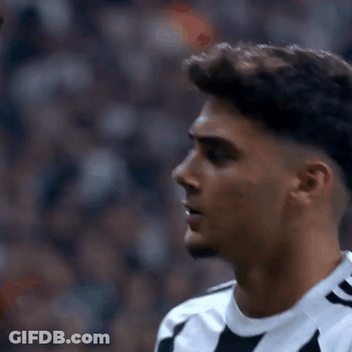 Soccer Player In Black And White Striped Shirt Looking At Camera GIF