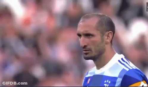 Soccer Player In Blue And White Shirt Standing On Field GIF