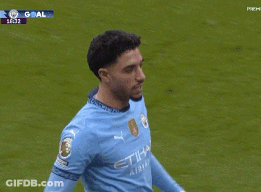 Soccer Player In Blue Jersey Being Hugged GIF