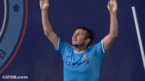 Soccer Player In Blue Jersey With Poppy Before Crowd GIF