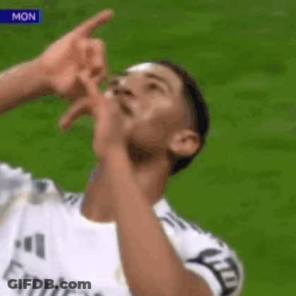 Soccer Player In Fly Emirates Jersey Pointing Up GIF