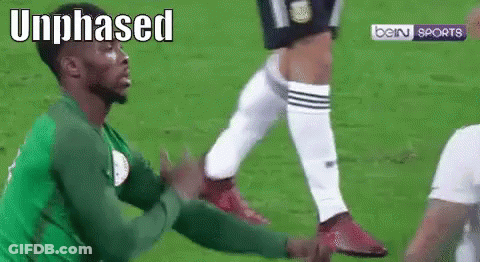 Soccer Player In Green Jersey Being Tackled GIF