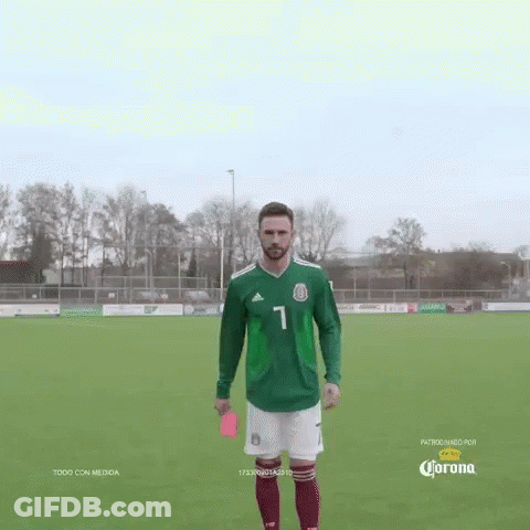 Soccer Player In Green Jersey Holds Red Card GIF