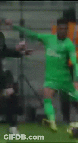Soccer Player In Green Jersey Kicking Soccer Ball GIF