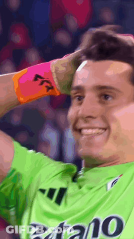 Soccer Player In Green Shirt With Zatano Smiling GIF