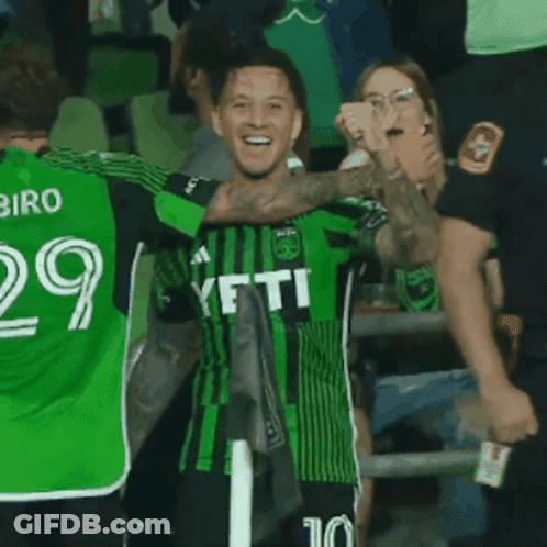 Soccer Player In Green Yeti Jersey Celebrates With Teammates GIF