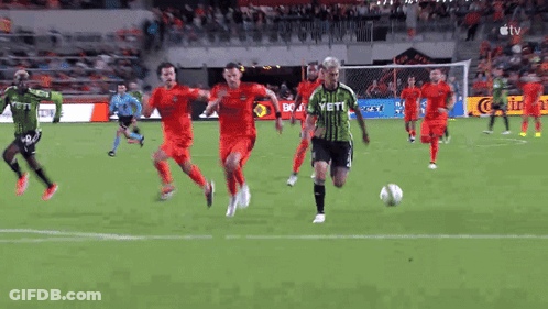 Soccer Player In Green Yeti Jersey Kicking Ball GIF