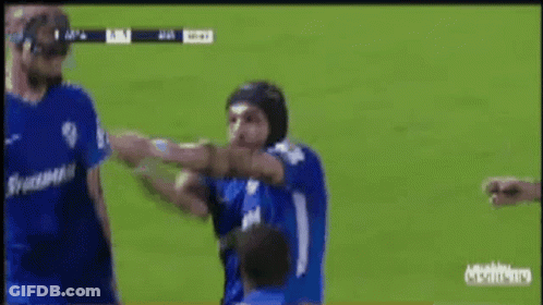 Soccer Player In Helmet Punched By Another Player GIF
