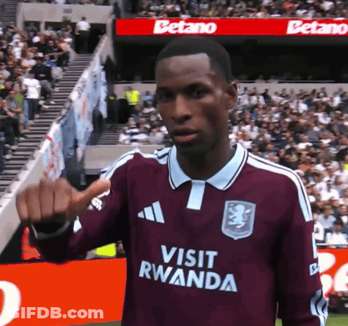 Soccer Player In Maroon Jersey Saying Visit Rwanda GIF