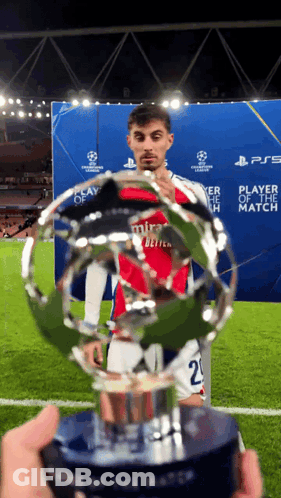 Soccer Player In Mira Jersey Holding Trophy GIF