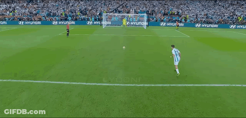 Soccer Player In Number 12 Jersey Kicking Ball Into Goal GIF