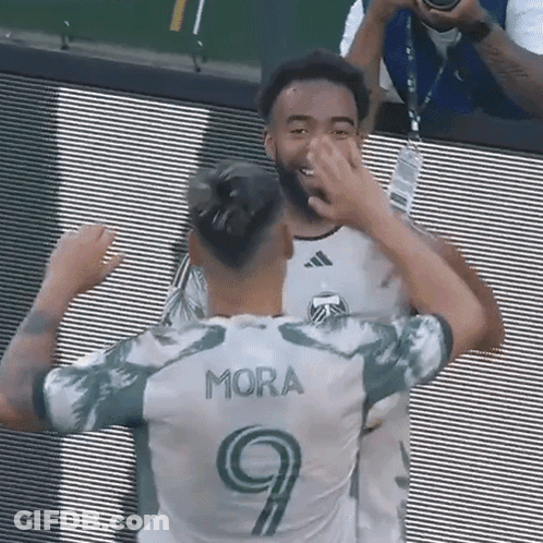Soccer Player In Number 9 Jersey Hugging Another Player GIF