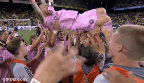 Soccer Player In Pink Shirt Thrown In Air GIF