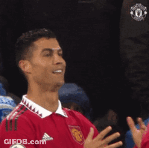 Soccer Player In Red Adidas Jersey Smiling And Clapping GIF