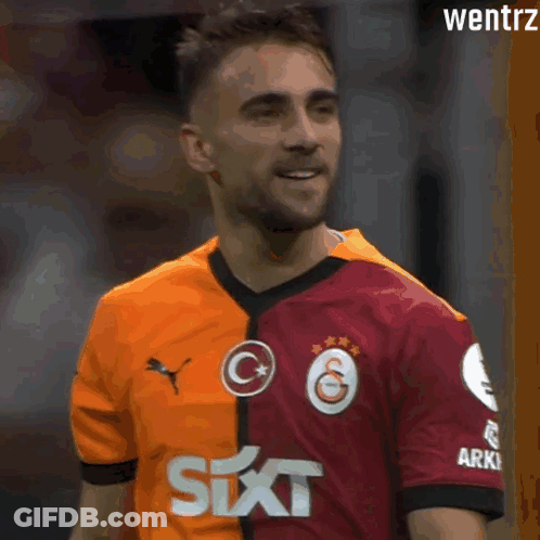 Soccer Player In Red And Orange Jersey With Six On Sleeve GIF