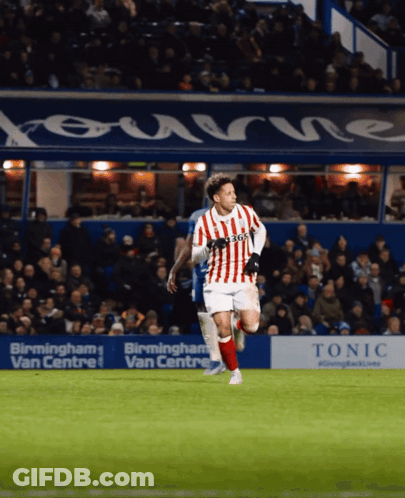 Soccer Player In Red And White Jersey Running Past Birmingham Ad GIF