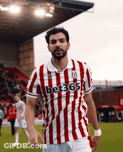 Soccer Player In Red And White Striped Shirt Saying Bet365 GIF