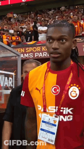 Soccer Player In Red And Yellow Jersey With Letter G GIF