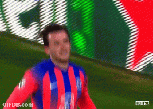 Soccer Player In Red Blue White Striped Shirt In Front Of Heineken Sign GIF