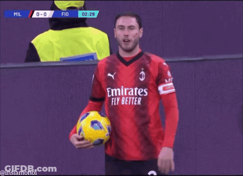 Soccer Player In Red Emirates Fly Bet Jersey Holding Yellow Ball GIF