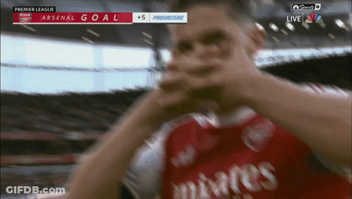 Soccer Player In Red Emirates Jersey Celebrates Goal GIF