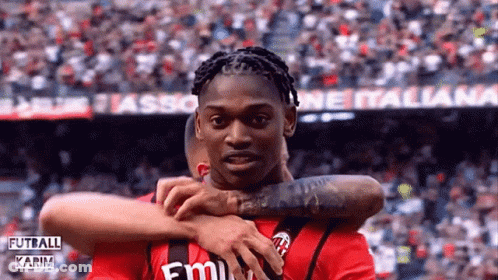 Soccer Player In Red Emirates Shirt Hugging Another GIF