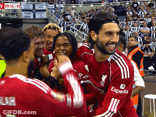 Soccer Player In Red Expedia Jersey Surrounded By Players GIF
