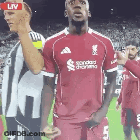 Soccer Player In Red Jersey Saying Standard Chartered GIF