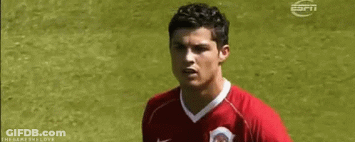 Soccer Player In Red Jersey Standing On Field GIF