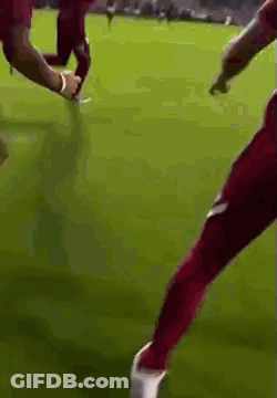 Soccer Player In Red Pants Kicking Soccer Ball GIF