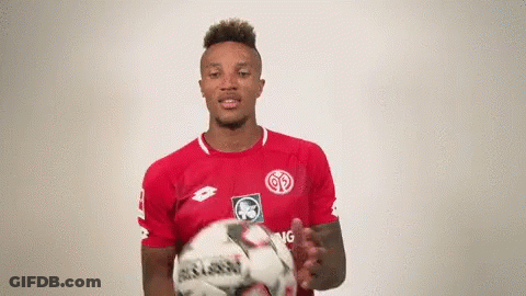 Soccer Player In Red Shirt Holding Ball GIF