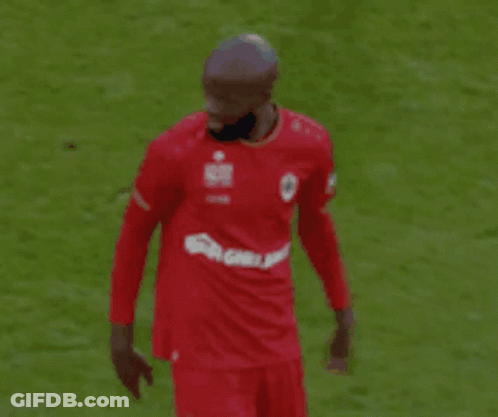Soccer Player In Red Shirt Pointing At Field GIF