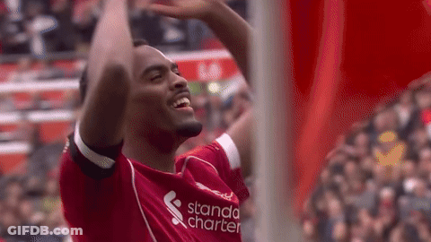Soccer Player In Red Shirt Raising Arms GIF