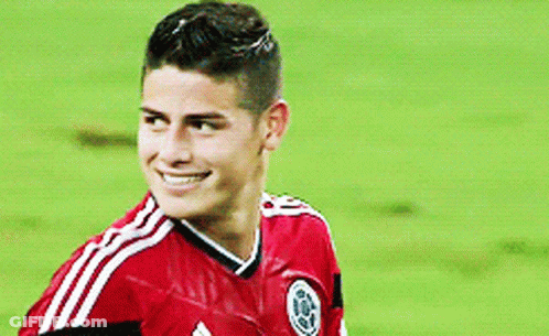 Soccer Player In Red Shirt Scratching Head On Field GIF
