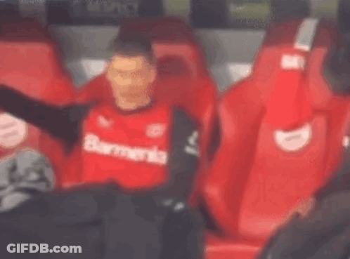 Soccer Player In Red Shirt Sitting In Stands GIF
