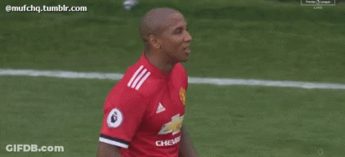 Soccer Player In Red Shirt Talking To Another Player GIF