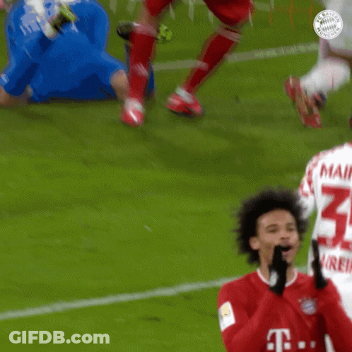 Soccer Player In Red Shirt With Letter T On Field GIF