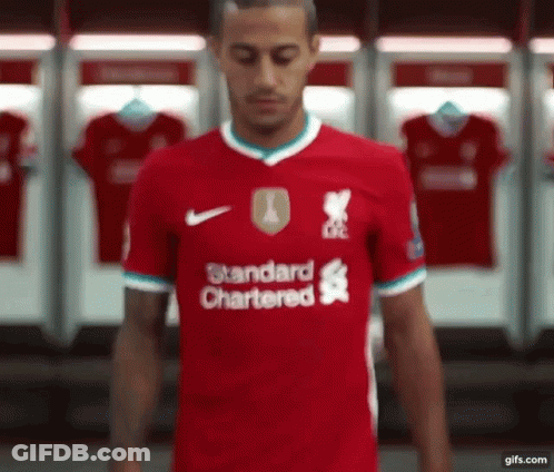 Soccer Player In Red Standard Chartered Jersey In Locker Room GIF