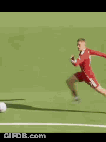 Soccer Player In Red Uniform Kicking Ball GIF