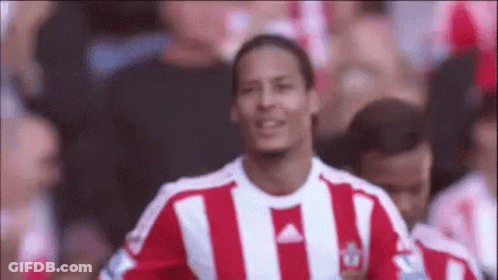 Soccer Player In Red White Striped Shirt Smiling With Crowd GIF