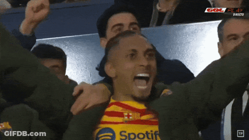 Soccer Player In Spotify Shirt Celebrating With Teammates GIF