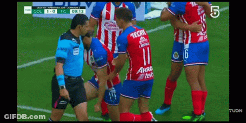 Soccer Player In Tecate Jersey Being Helped Off Field GIF