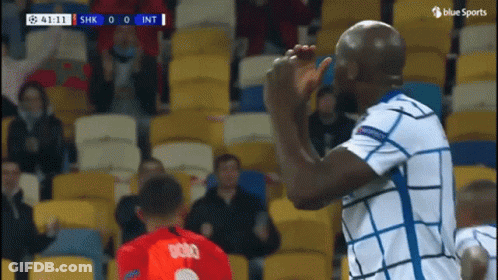 Soccer Player In White And Blue High Fiving Another GIF