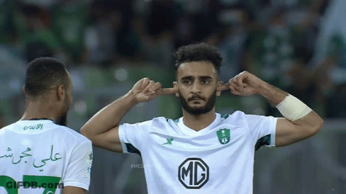 Soccer Player In White MC Shirt Covering Ears GIF