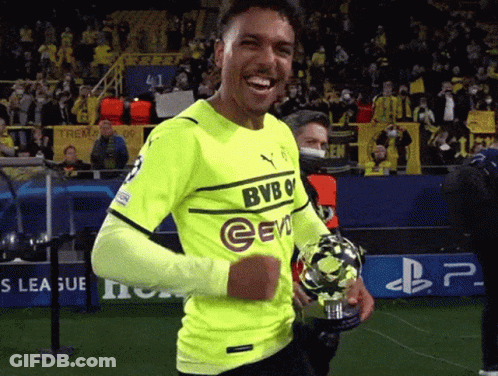 Soccer Player In Yellow BVB Jersey Holding Trophy GIF